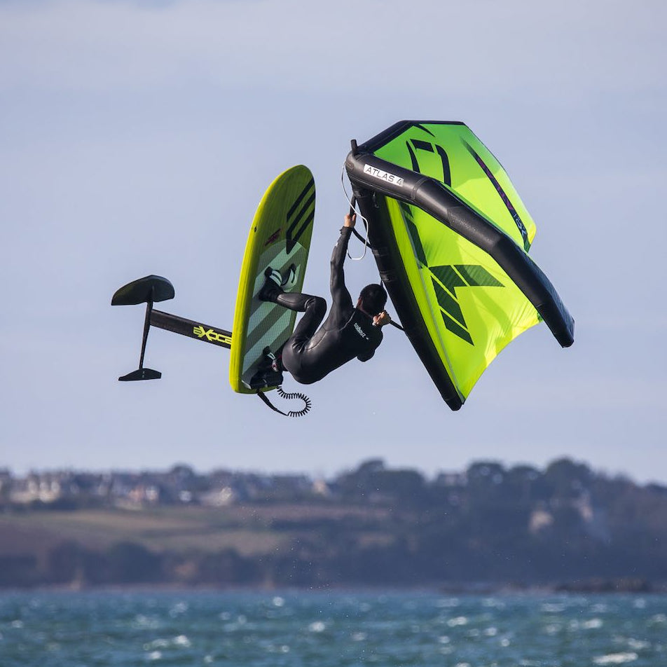 Person wingfoiling with an XO wingfoil sail over a body of water